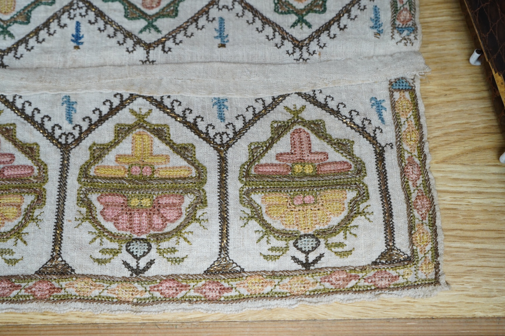 Two 19th century Turkish hand embroidered towel ends sewn together later as a table centre. Worked on fine hand woven linen in polychrome silks with gold metallic thread fillings, 39.5cm wide x 26.5cm deep. Condition - t
